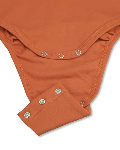 Extender for orange bodysuit, fastened with snap buttons.