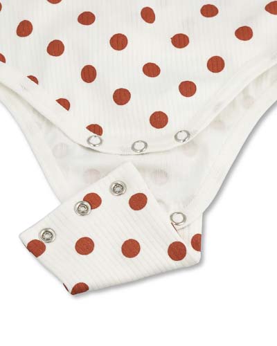 Extender for wrap-around bodysuit with dot pattern, fastened with snap buttons.