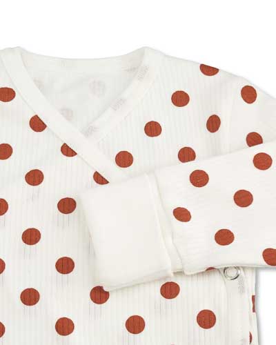 Wrap-around bodysuit with dot pattern, cuff with foldable stretch fabric.